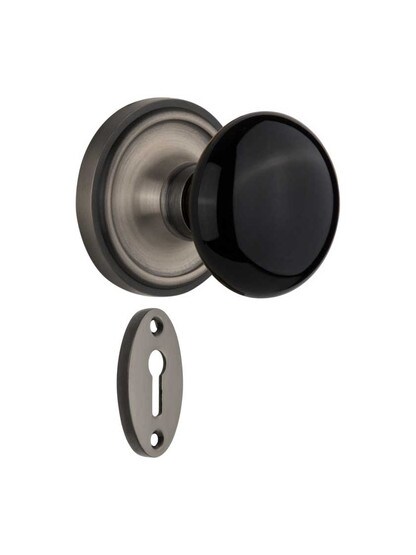 Classic Rosette Mortise-Lock Set with Black Porcelain Knobs in Antique Pewter.
